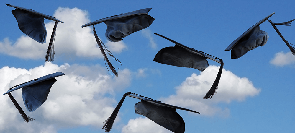 Graduation caps thrown into the sky.