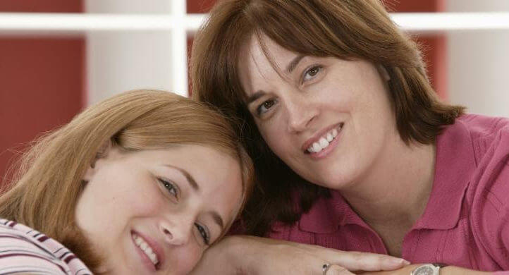 Avoid-Homeschool-Mom-Burnout-mom and daughter leaning on each other smiling