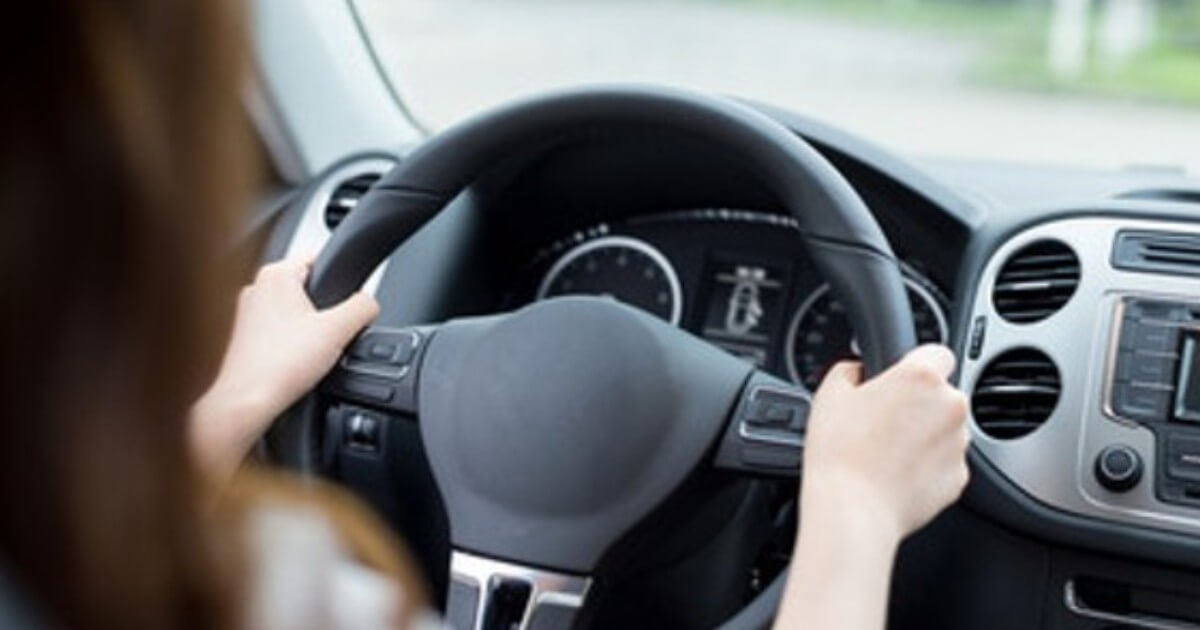 student hands on steering wheel