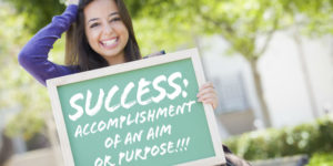 success scholarship-girl holding success sign