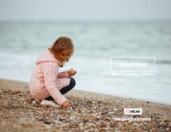 girl on beach picking sea shells