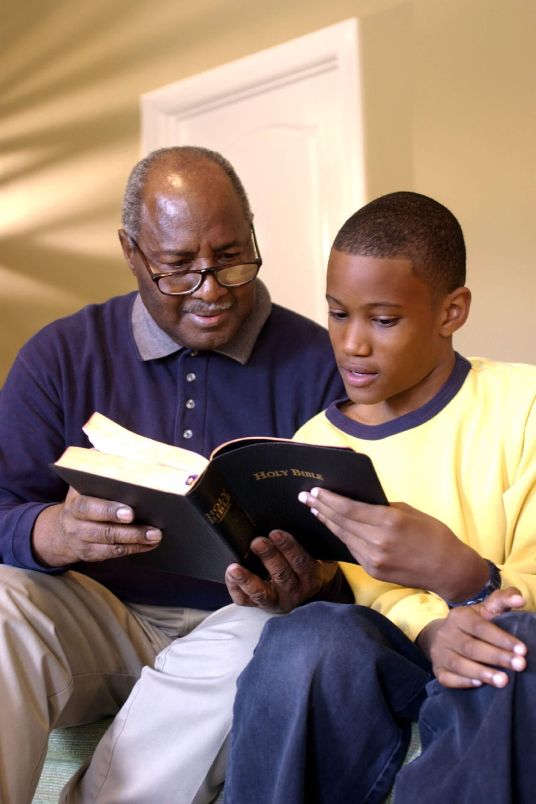 grandfather and grandson reading bible