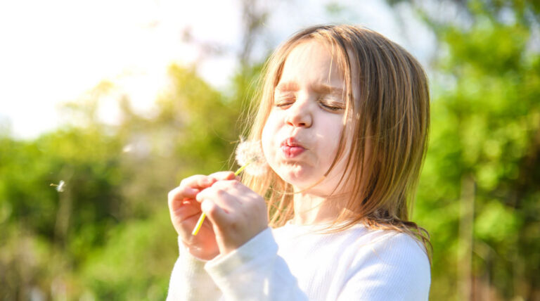 member benefit girl blowing dandilion